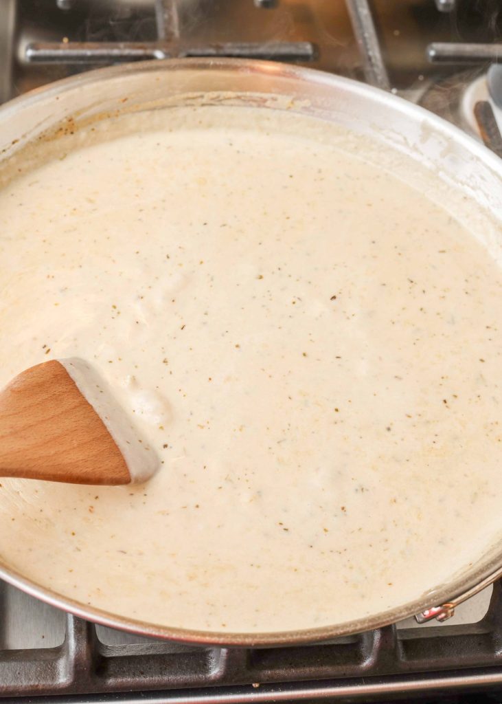 cream sauce with wooden spoon in large skillet