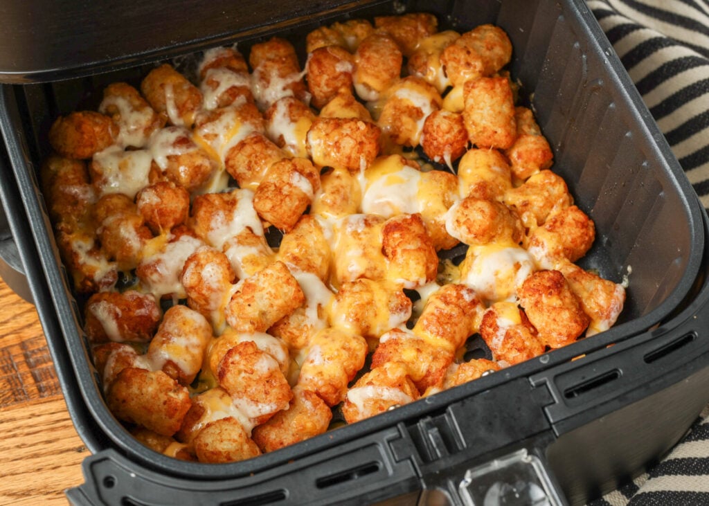 The cheese has melted over the tots and looks gooey and delicious.