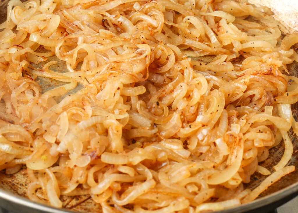 The onions have begun to turn translucent in the first stage of caramelization.