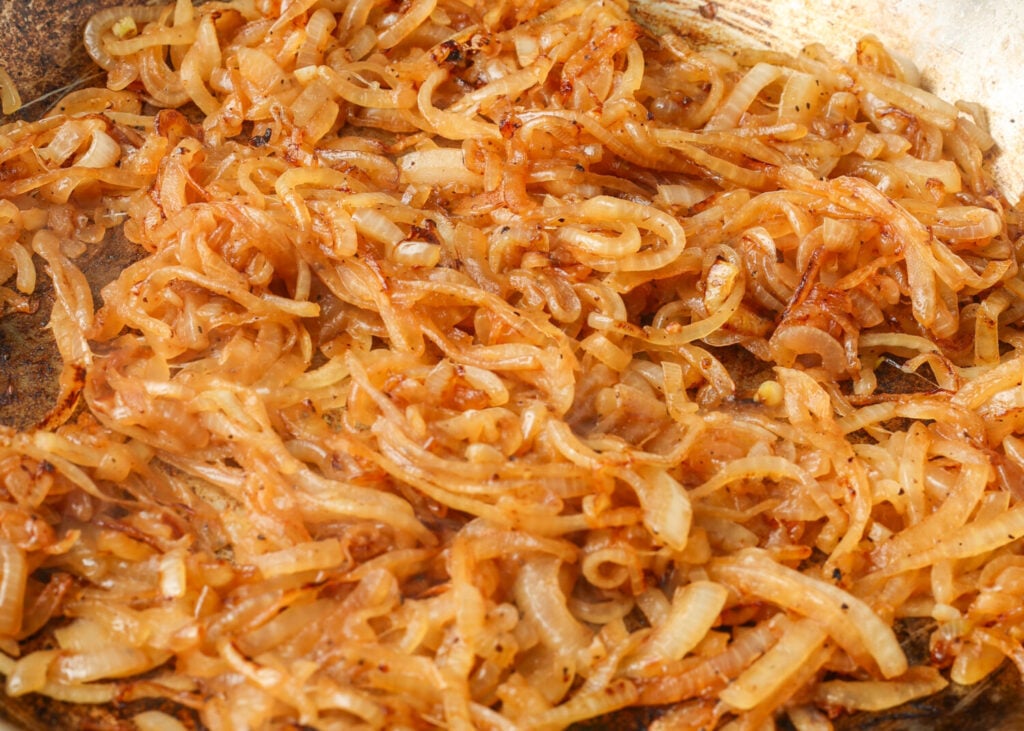 A close up of the onions about halfway through caramelizing.
