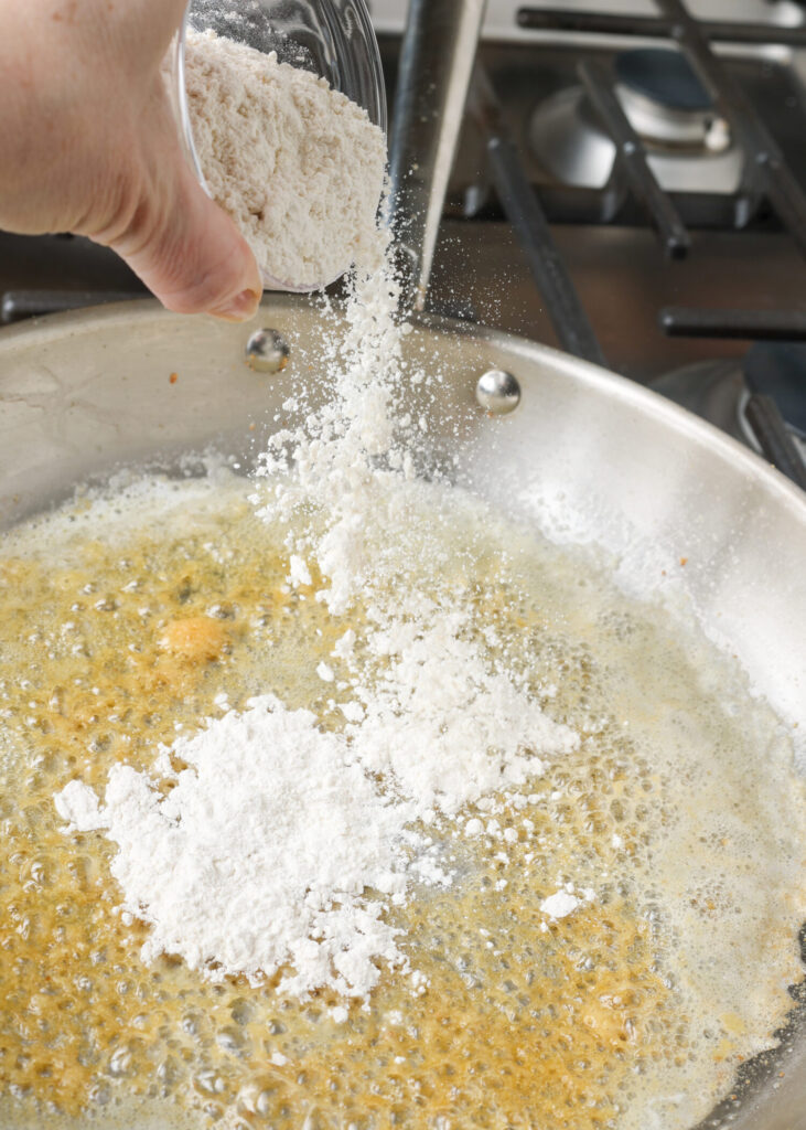 sauteeing garlic and adding flour to skillet