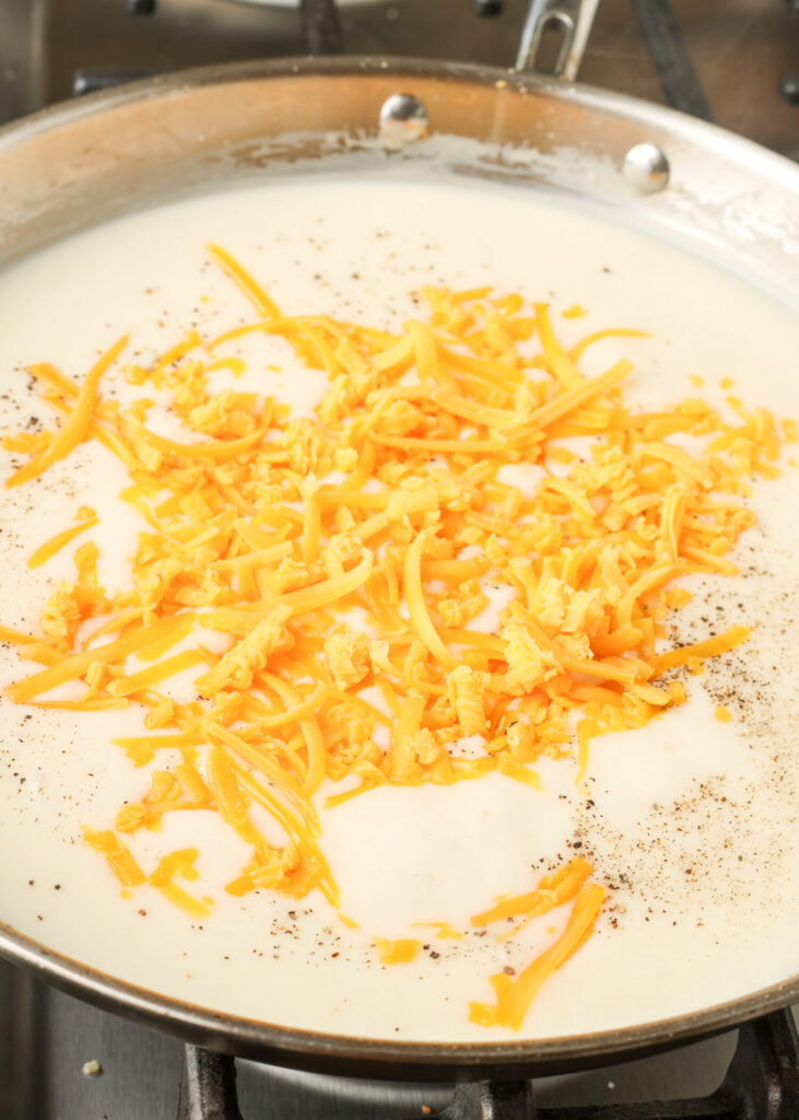 adding cheese to pan