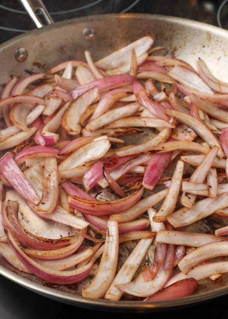 Sauteed red onions in stainless skillet