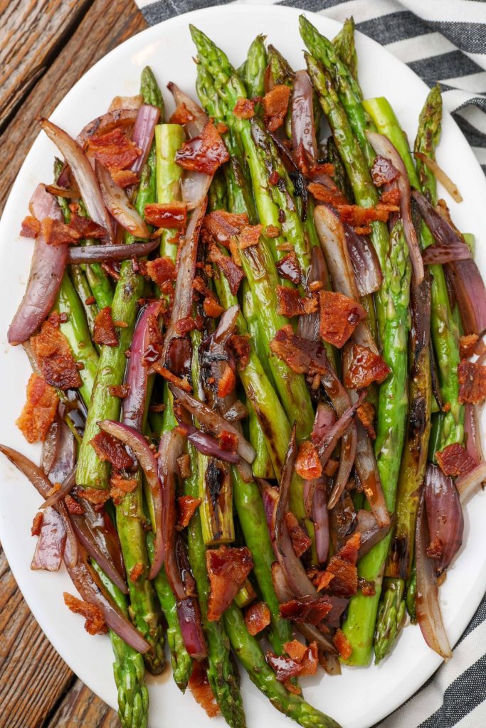 oval platter with sauteed asparagus and onion