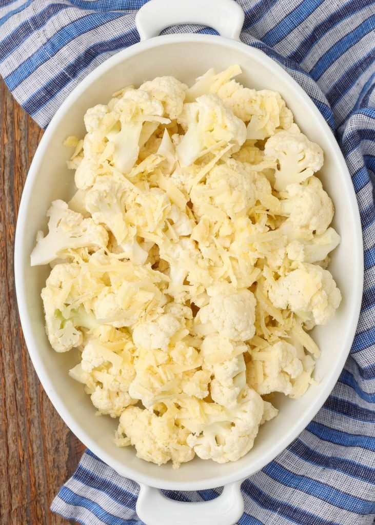 cauliflower topped with cheese in white baker