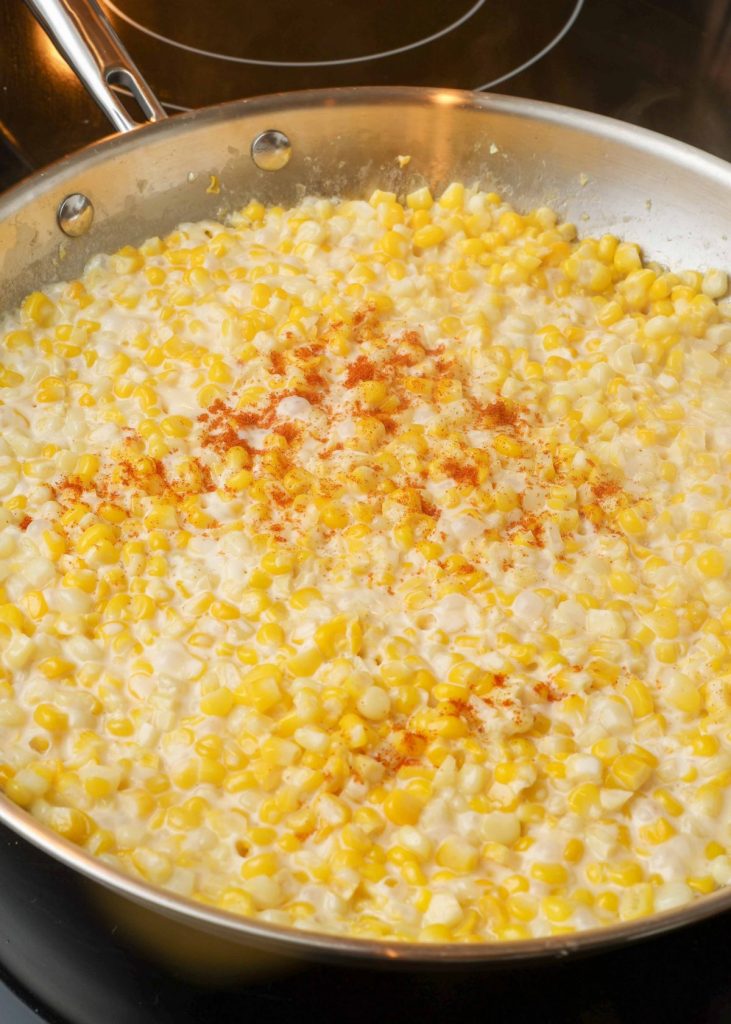 fresh creamed corn in stainless skillet