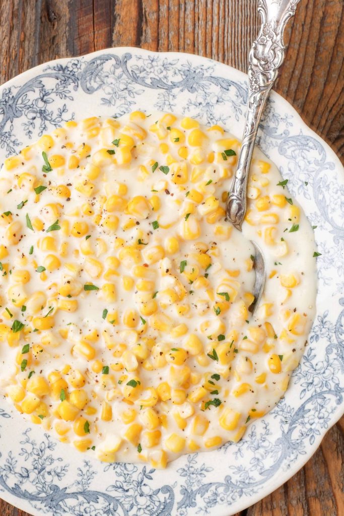 creamed corn in bowl with spoon 