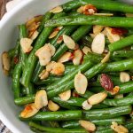 green beans and almonds in white serving dish