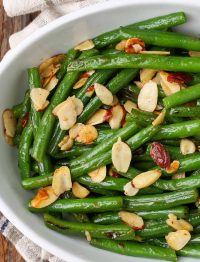 green beans and almonds in white serving dish