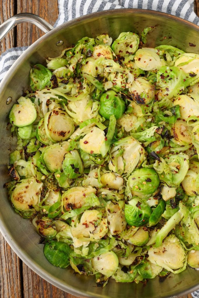 sauteed Brussels in skillet with tea towel