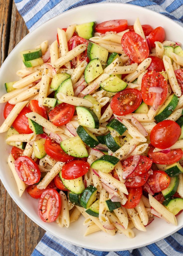 Zucchini Pasta Salad with tomatoes in bowl with napkin