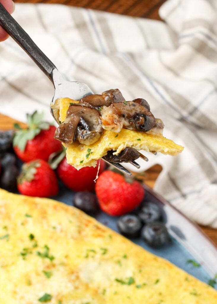 bite of mushroom omelet on fork