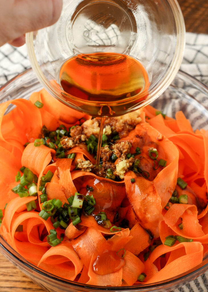 adding dressing to salad